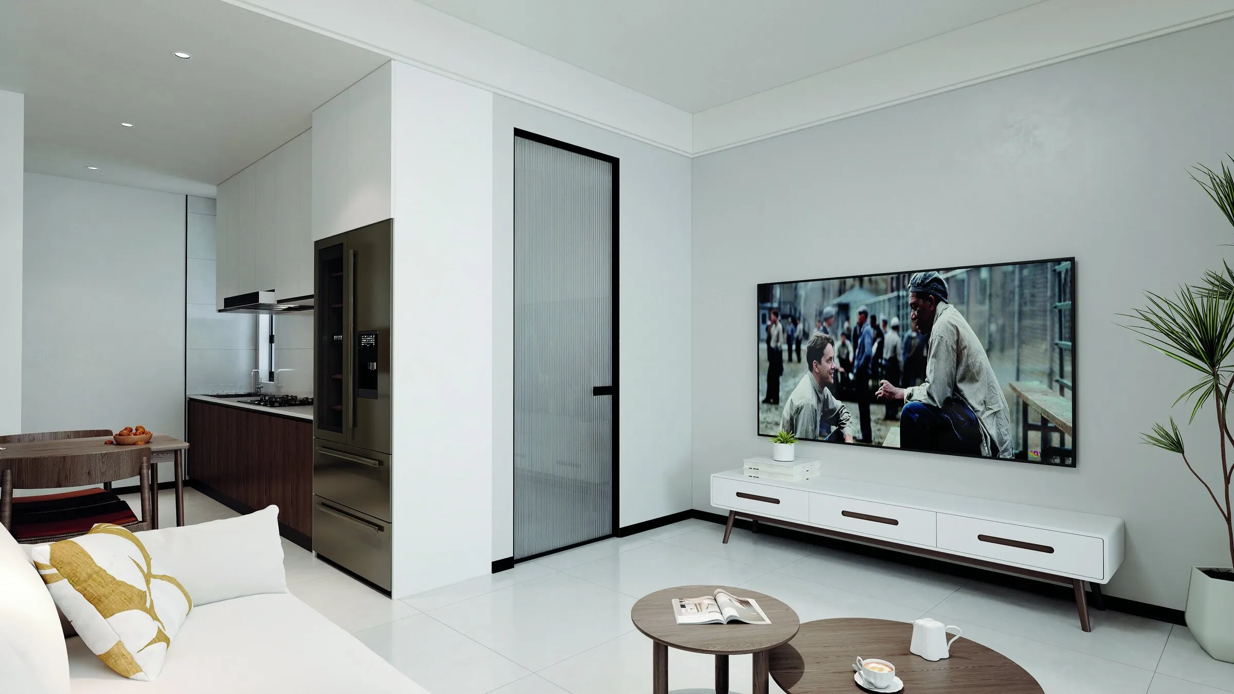 Living room with a white sofa, wall-mounted TV and a tall fridge in the kitchen beyond