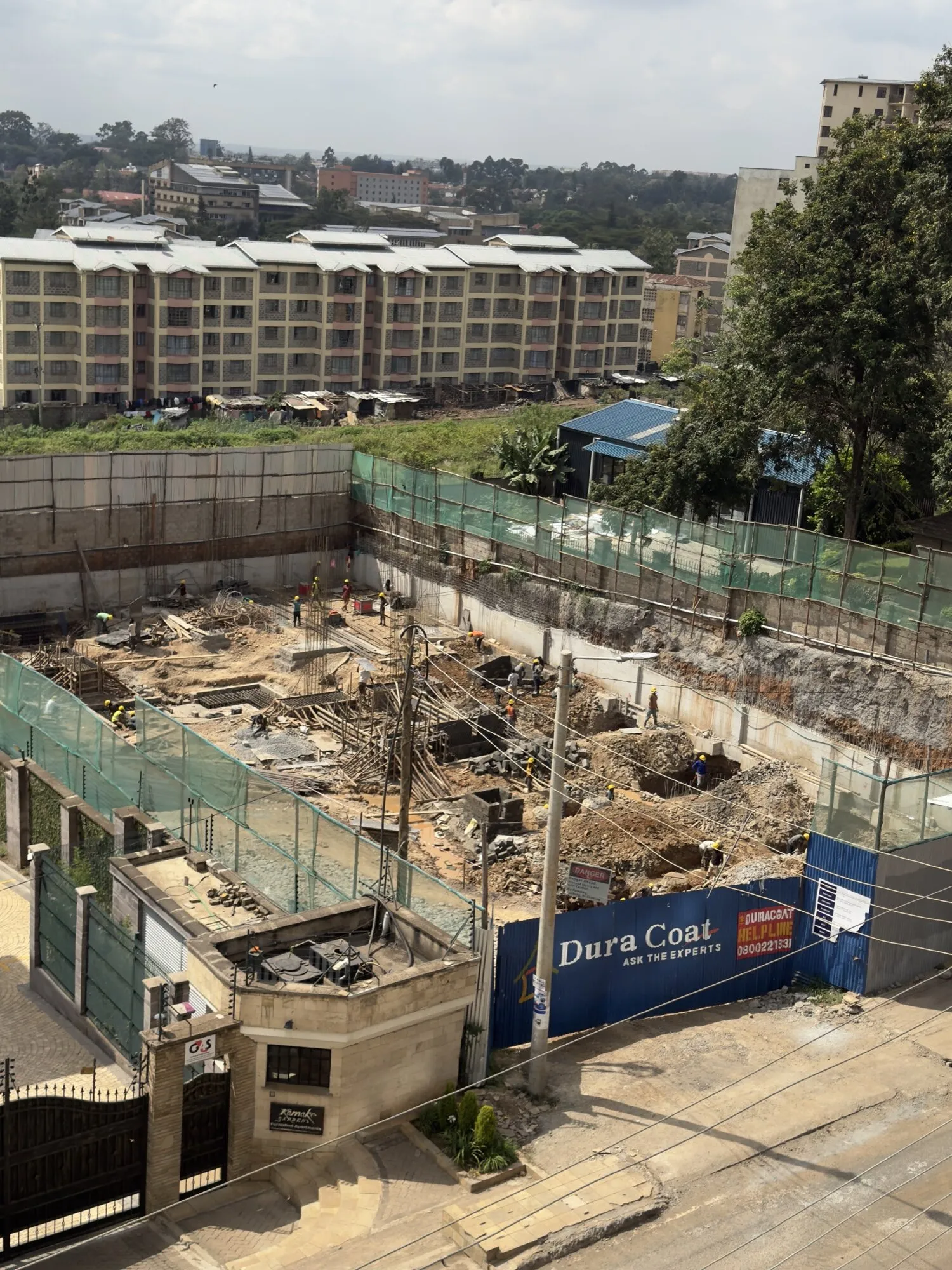 Foundation works below street level, with pile caps and reinforcement across the site