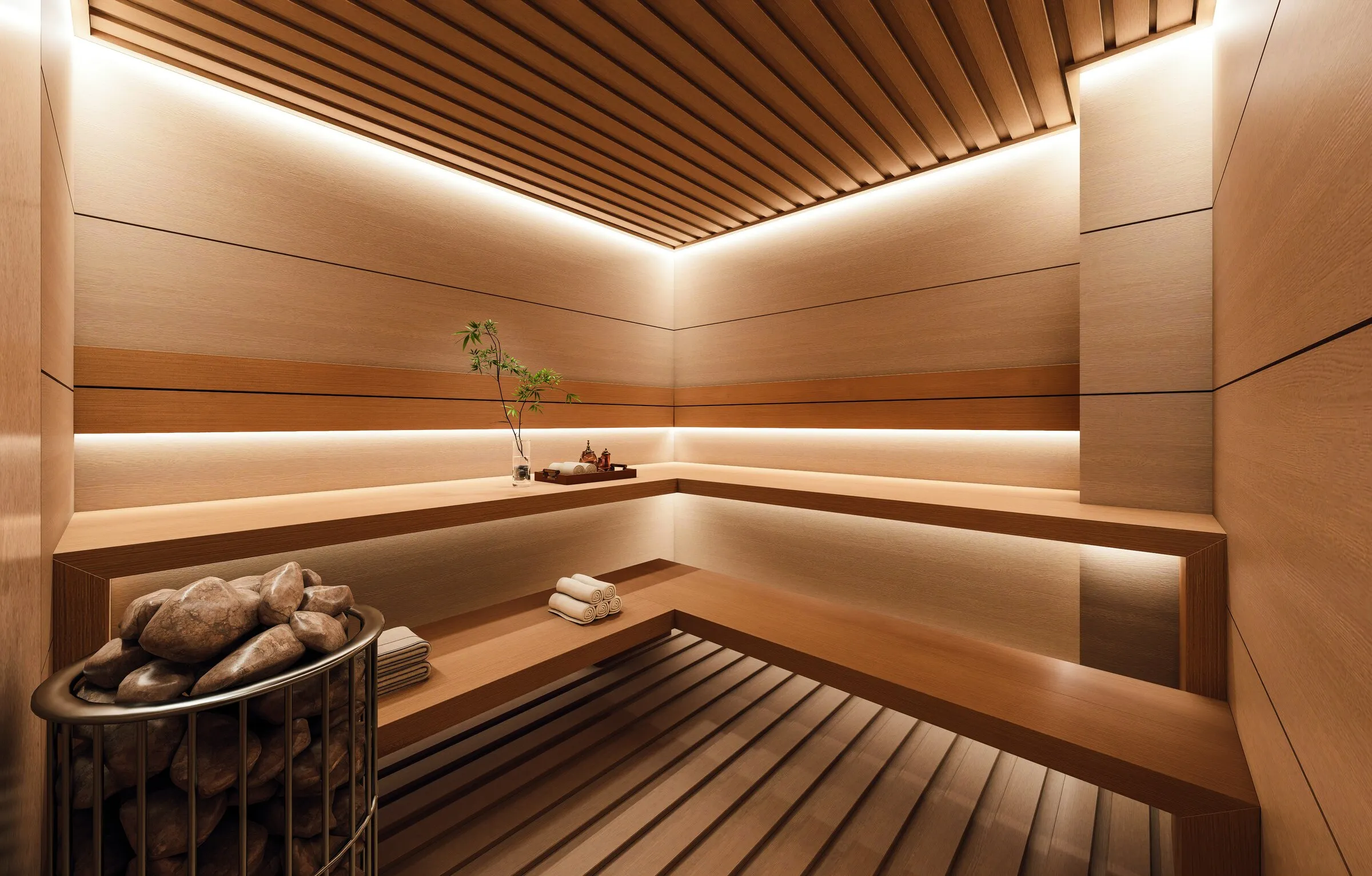 Timber-lined sauna with benches and a stone heater